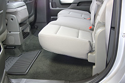 The DU-HA fits underneath the pre-existing back seats of your truck. 